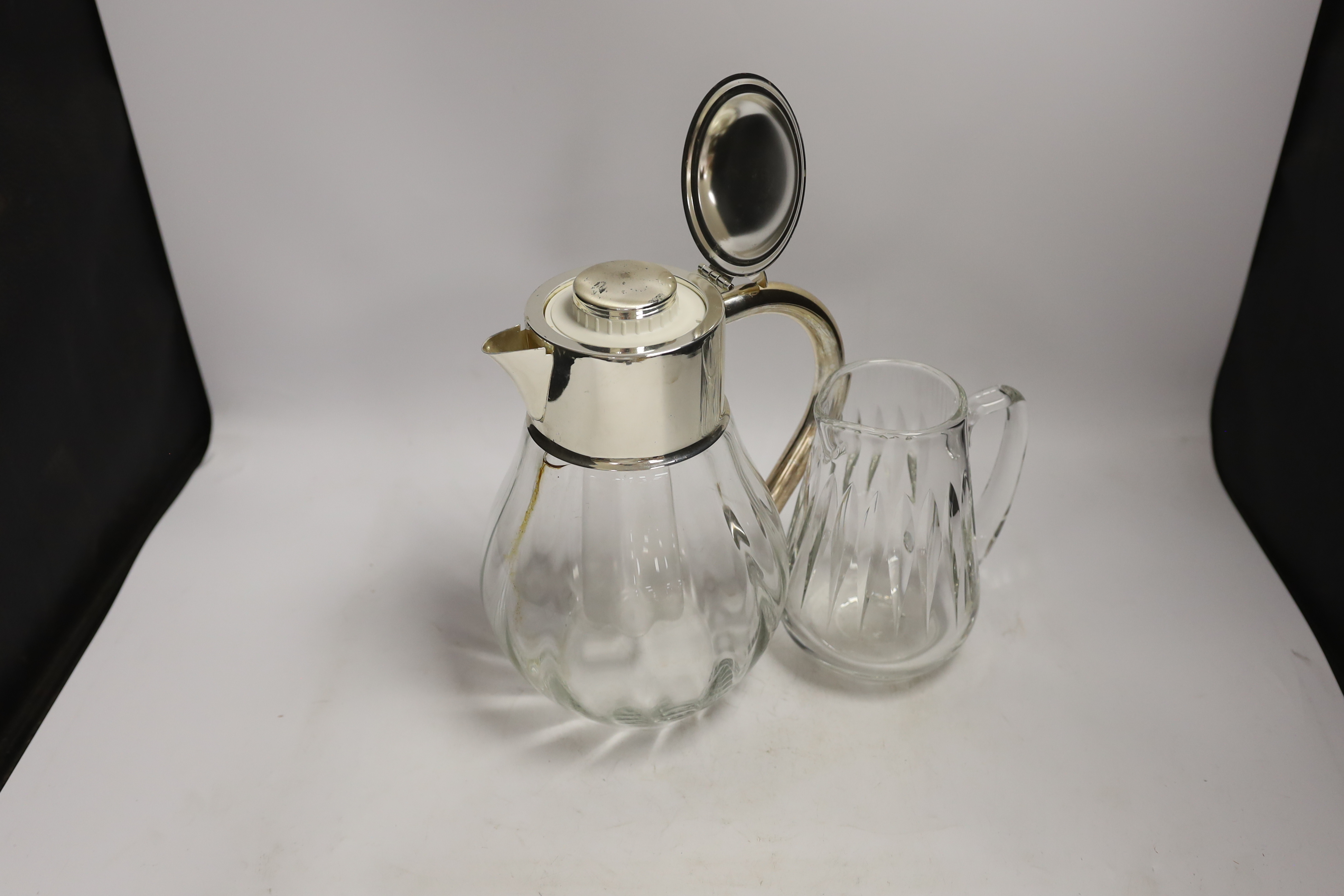 A silver plate mounted lemonade / Pimms jug and a glass jug, largest 28cm (2)